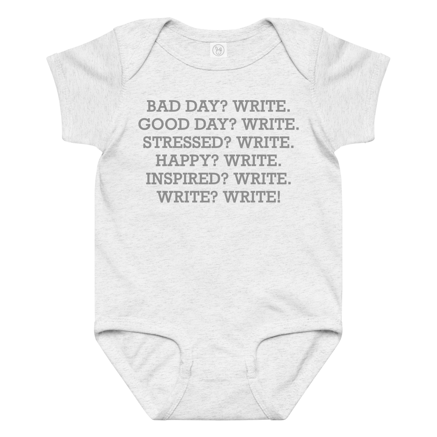 "Bad Day? Write. Good Day? Write. Stressed? Write. Happy? Write. Inspired? Write. Write? Write!" printed on a ash baby jersey bodysuit laying on a flat surface amongst other clothes