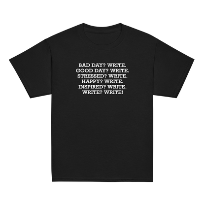 "Bad Day? Write. Good Day? Write. Stressed? Write. Happy? Write. Inspired? Write. Write? Write!" printed on a black youth classic tee laying on a flat surface