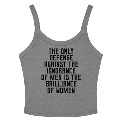 "The Only defense against the ignorance of men is the brilliance of women" printed on a athletic heather women's micro-rib tanktop laying on a flat surface amongst sunglasses and shorts