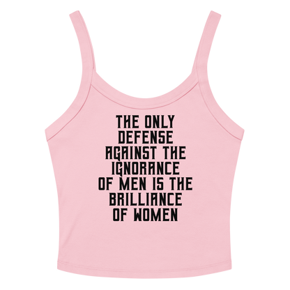 "The Only defense against the ignorance of men is the brilliance of women" printed on a solid pink blend women's micro-rib tanktop laying on a flat surface amongst sunglasses and shorts