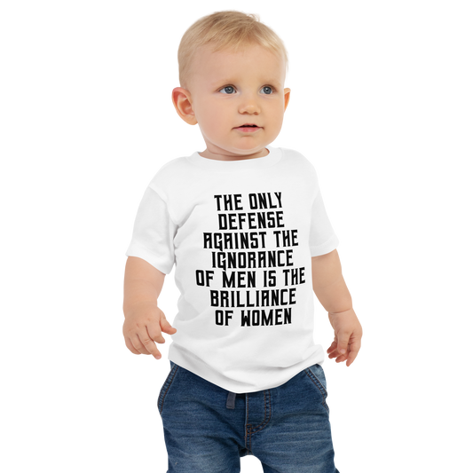 "The Only defense against the ignorance of men is the brilliance of women" printed on a white baby jersey short sleeve tee worn by a male