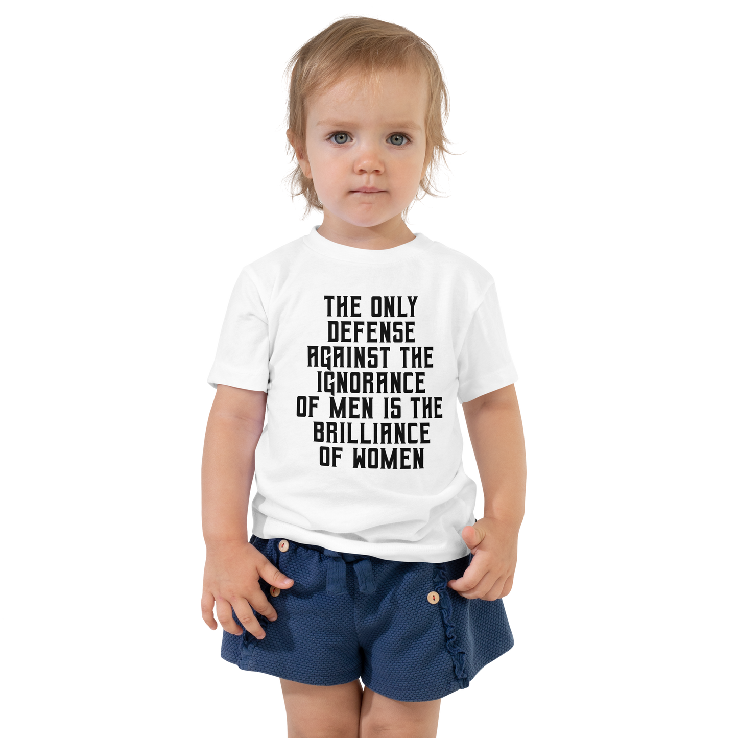 "The Only defense against the ignorance of men is the brilliance of women" printed on a white toddler short sleeve tee worn by a female