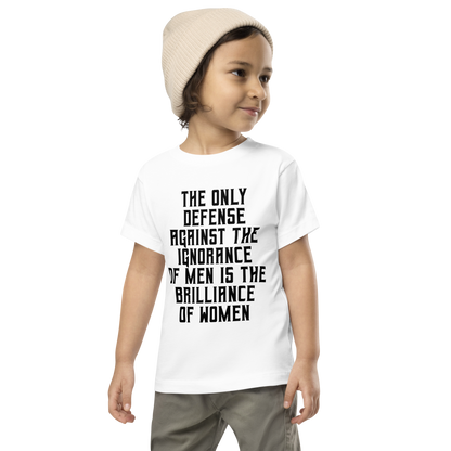 "The Only defense against the ignorance of men is the brilliance of women" printed on a white toddler short sleeve tee worn by a male wearing a cap