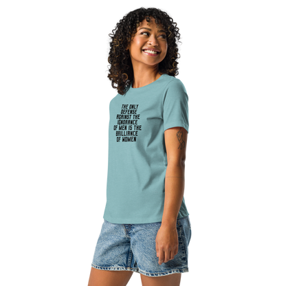 "The Only defense against the ignorance of men is the brilliance of women" printed on a heather blue lagoon women's relaxed t-shirt worn by a female
