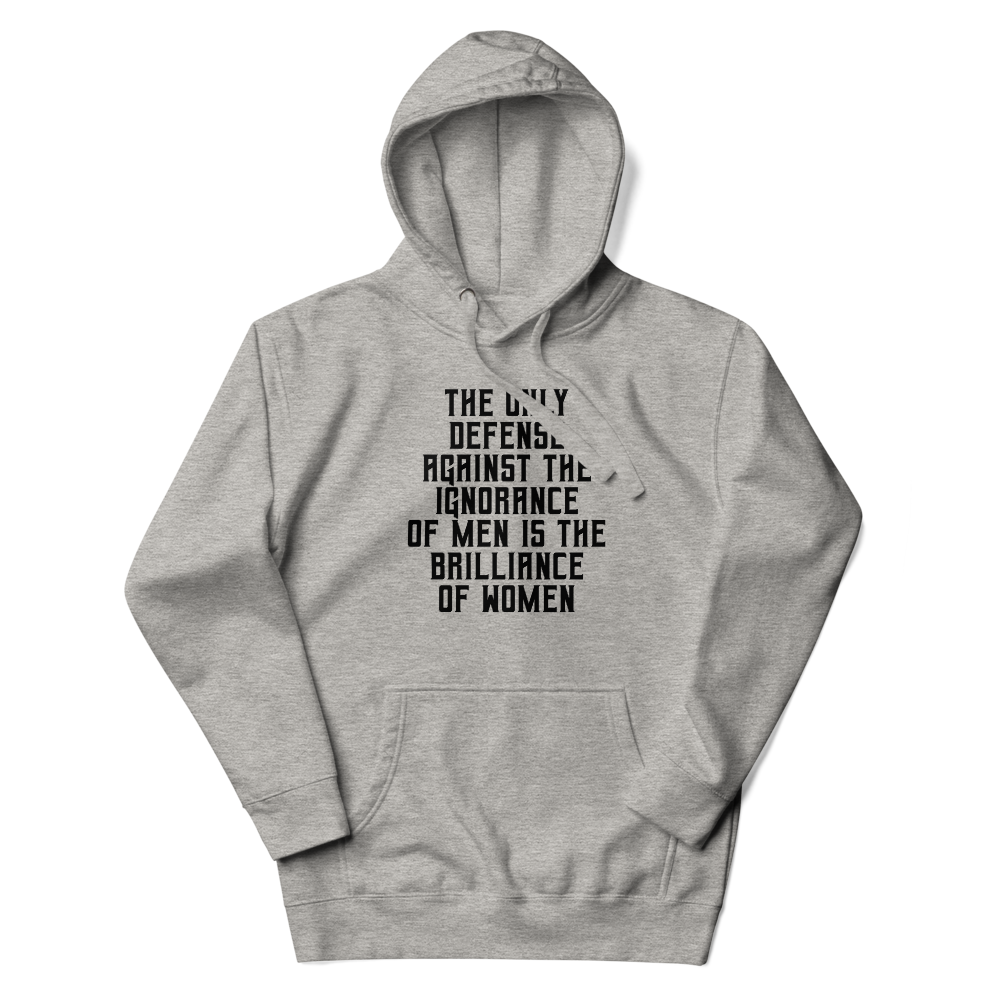 "The Only defense against the ignorance of men is the brilliance of women" printed on a carbon grey unisex hoodie laying on a flat surface with the hood up