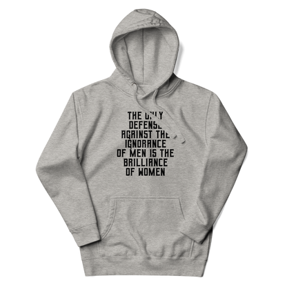 "The Only defense against the ignorance of men is the brilliance of women" printed on a carbon grey unisex hoodie laying on a flat surface with the hood up