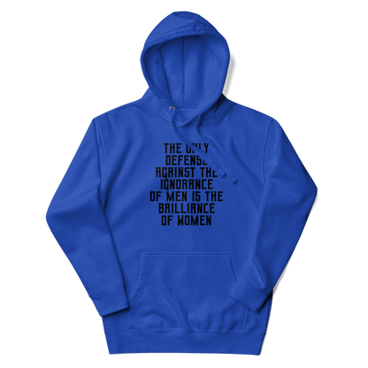 "The Only defense against the ignorance of men is the brilliance of women" printed on a team royal unisex hoodie laying on a flat surface with the hood up