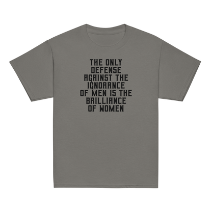 "The Only defense against the ignorance of men is the brilliance of women" printed on a charcoal youth classic tee laying on a flat surface