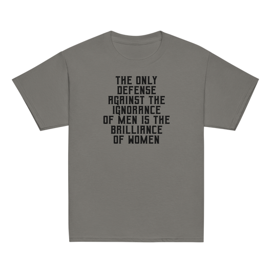 "The Only defense against the ignorance of men is the brilliance of women" printed on a charcoal youth classic tee laying on a flat surface