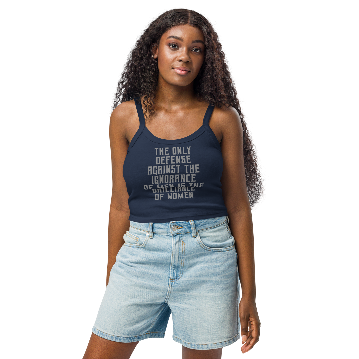 "The Only defense against the ignorance of men is the brilliance of women" printed on a solid navy blend women's micro-rib tanktop worn by a female
