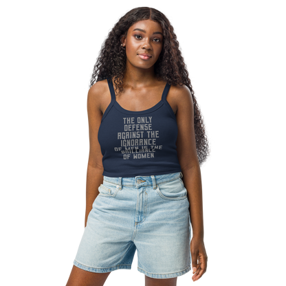 "The Only defense against the ignorance of men is the brilliance of women" printed on a solid navy blend women's micro-rib tanktop worn by a female