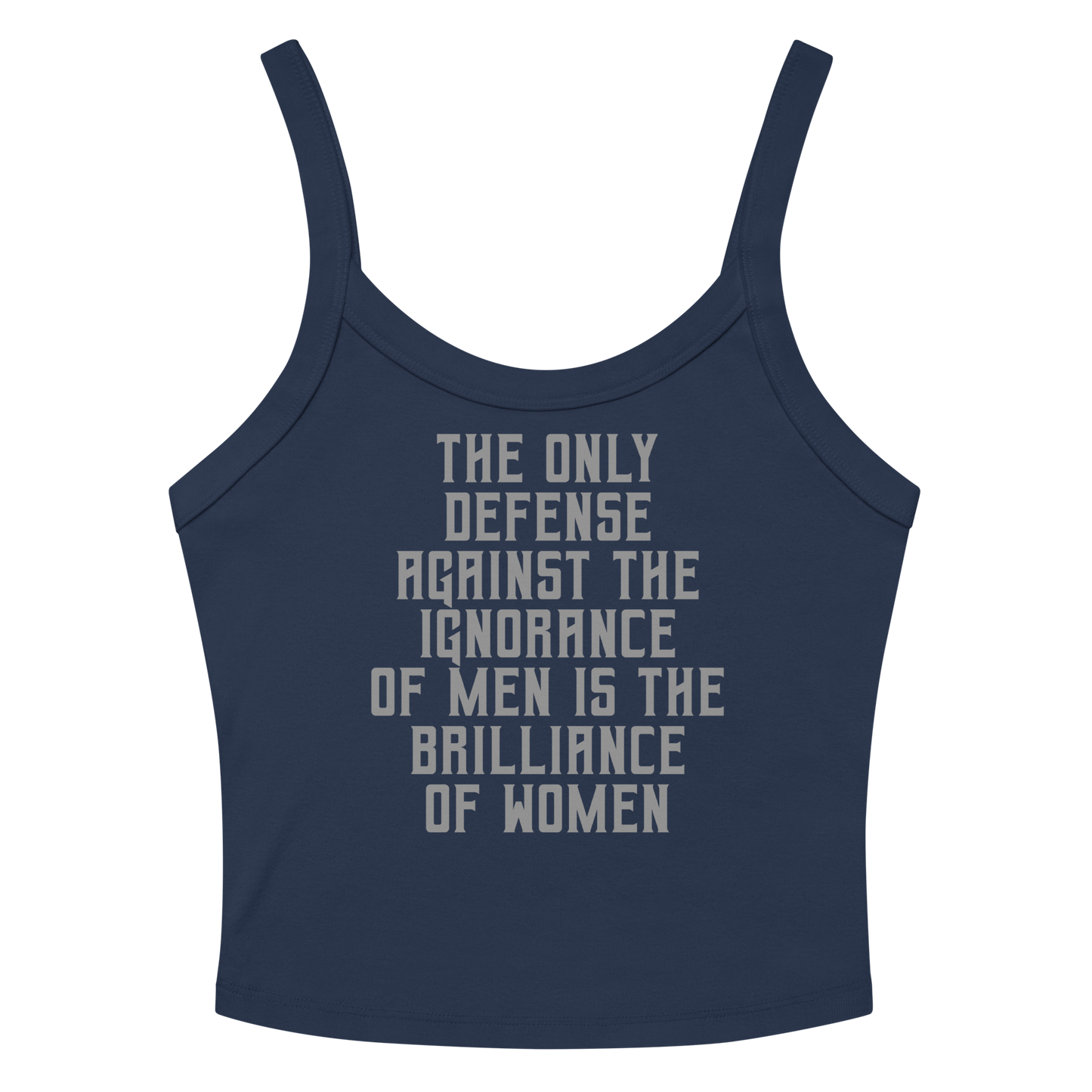"The Only defense against the ignorance of men is the brilliance of women" printed on a solid navy blend women's micro-rib tanktop laying on a flat surface amongst sunglasses and shorts