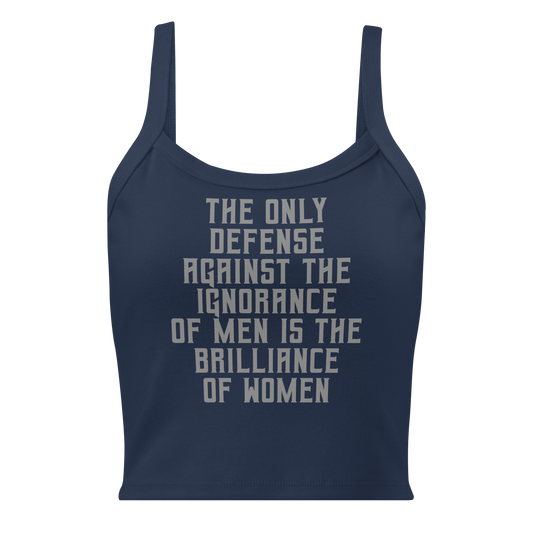 "The Only defense against the ignorance of men is the brilliance of women" printed on a solid navy blend women's micro-rib tanktop laying on a flat surface