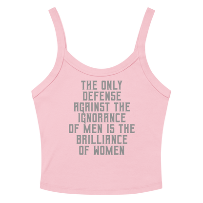 "The Only defense against the ignorance of men is the brilliance of women" printed on a solid pink blend women's micro-rib tanktop laying on a flat surface amongst sunglasses and shorts
