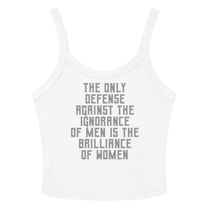 "The Only defense against the ignorance of men is the brilliance of women" printed on a solid white blend women's micro-rib tanktop laying on a flat surface amongst sunglasses and shorts