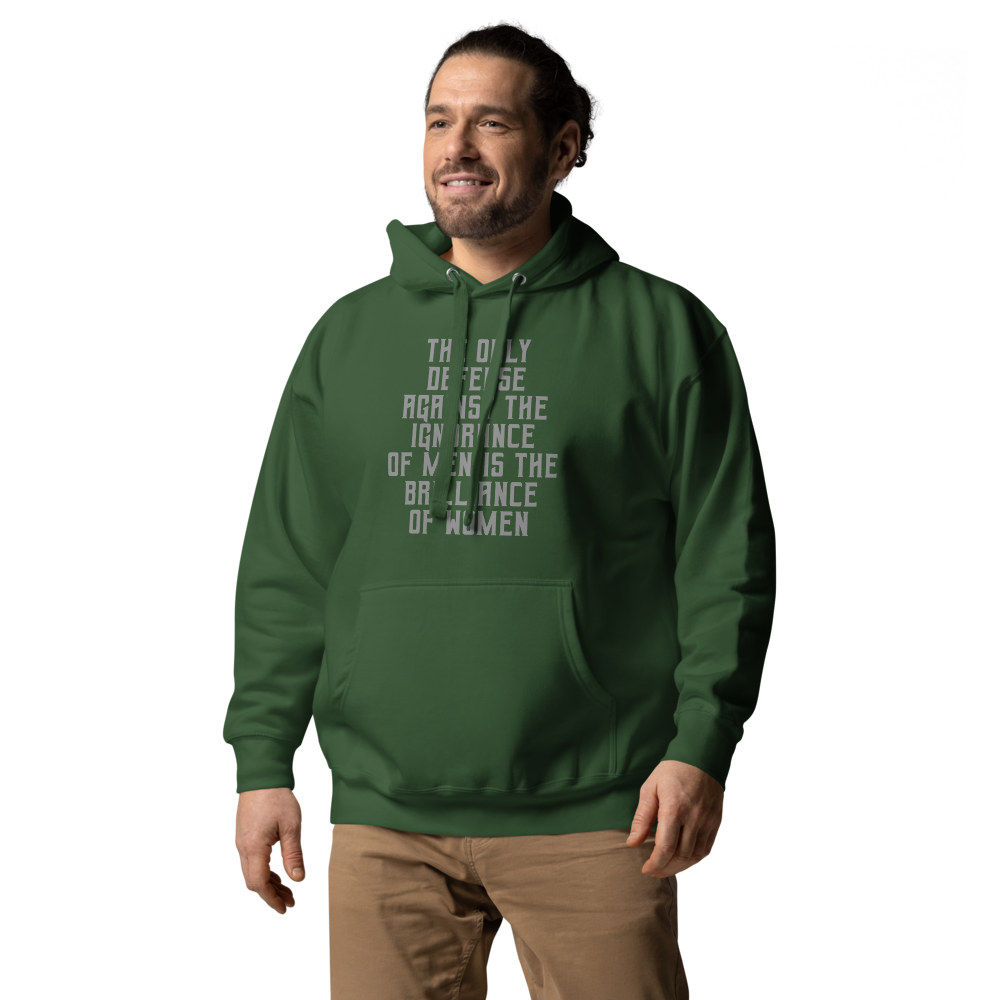 "The Only defense against the ignorance of men is the brilliance of women" printed on a forest green unisex hoodie worn by a male