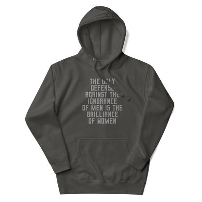 "The Only defense against the ignorance of men is the brilliance of women" printed on a vintage black unisex hoodie laying on a flat surface with the hood up