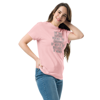 "The Only defense against the ignorance of men is the brilliance of women" printed on a light pink unisex classic tee worn by a female