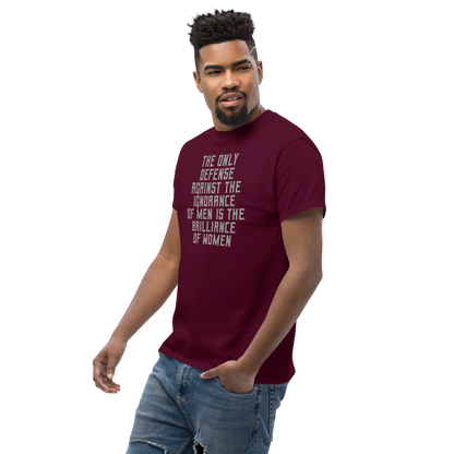 "The Only defense against the ignorance of men is the brilliance of women" printed on a maroon unisex classic tee worn by a male