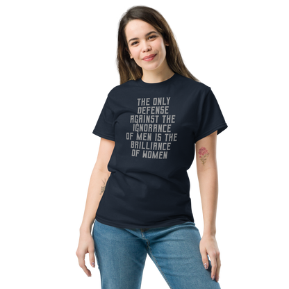 "The Only defense against the ignorance of men is the brilliance of women" printed on a navy unisex classic tee worn by a female