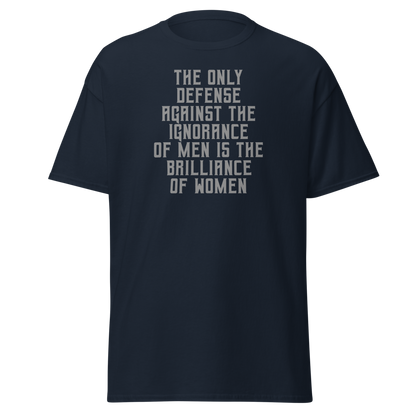 "The Only defense against the ignorance of men is the brilliance of women" printed on a navy unisex classic tee laying on a flat surface