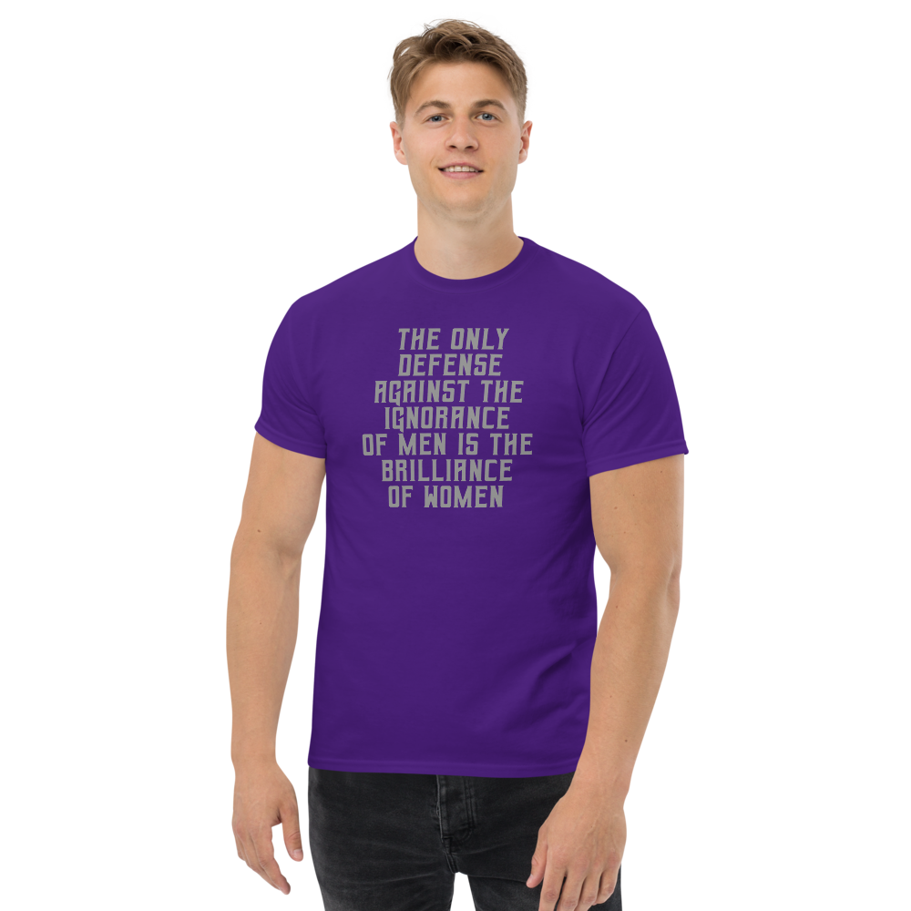 "The Only defense against the ignorance of men is the brilliance of women" printed on a purple unisex classic tee worn by a male