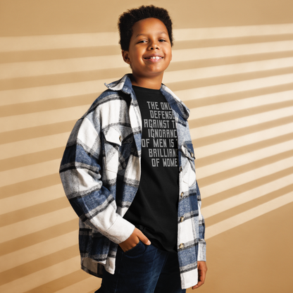 "The Only defense against the ignorance of men is the brilliance of women" printed on a black youth classic tee worn by a male also wearing a jacket