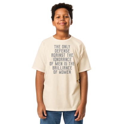 "The Only defense against the ignorance of men is the brilliance of women" printed on a natural youth classic tee worn by a male