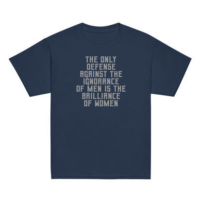 "The Only defense against the ignorance of men is the brilliance of women" printed on a navy youth classic tee laying on a flat surface