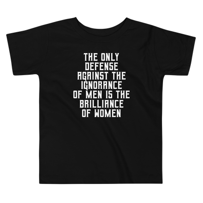 "The Only defense against the ignorance of men is the brilliance of women" printed on a black toddler short sleeve tee laying on a flat surface