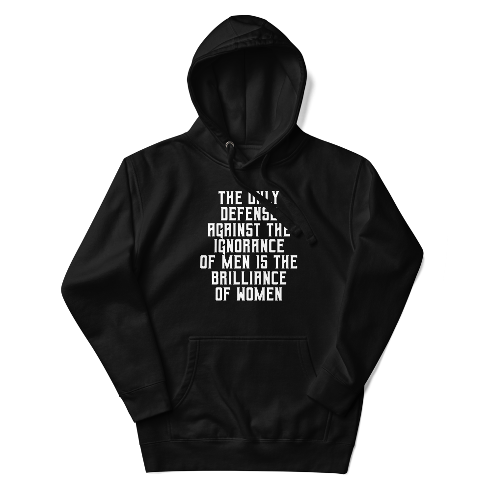 "The Only defense against the ignorance of men is the brilliance of women" printed on a black unisex hoodie laying on a flat surface with the hood up