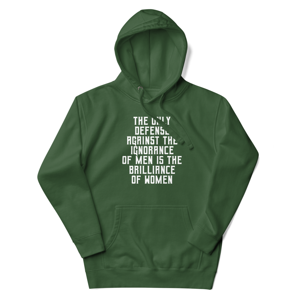 "The Only defense against the ignorance of men is the brilliance of women" printed on a forest green unisex hoodie laying on a flat surface with the hood up