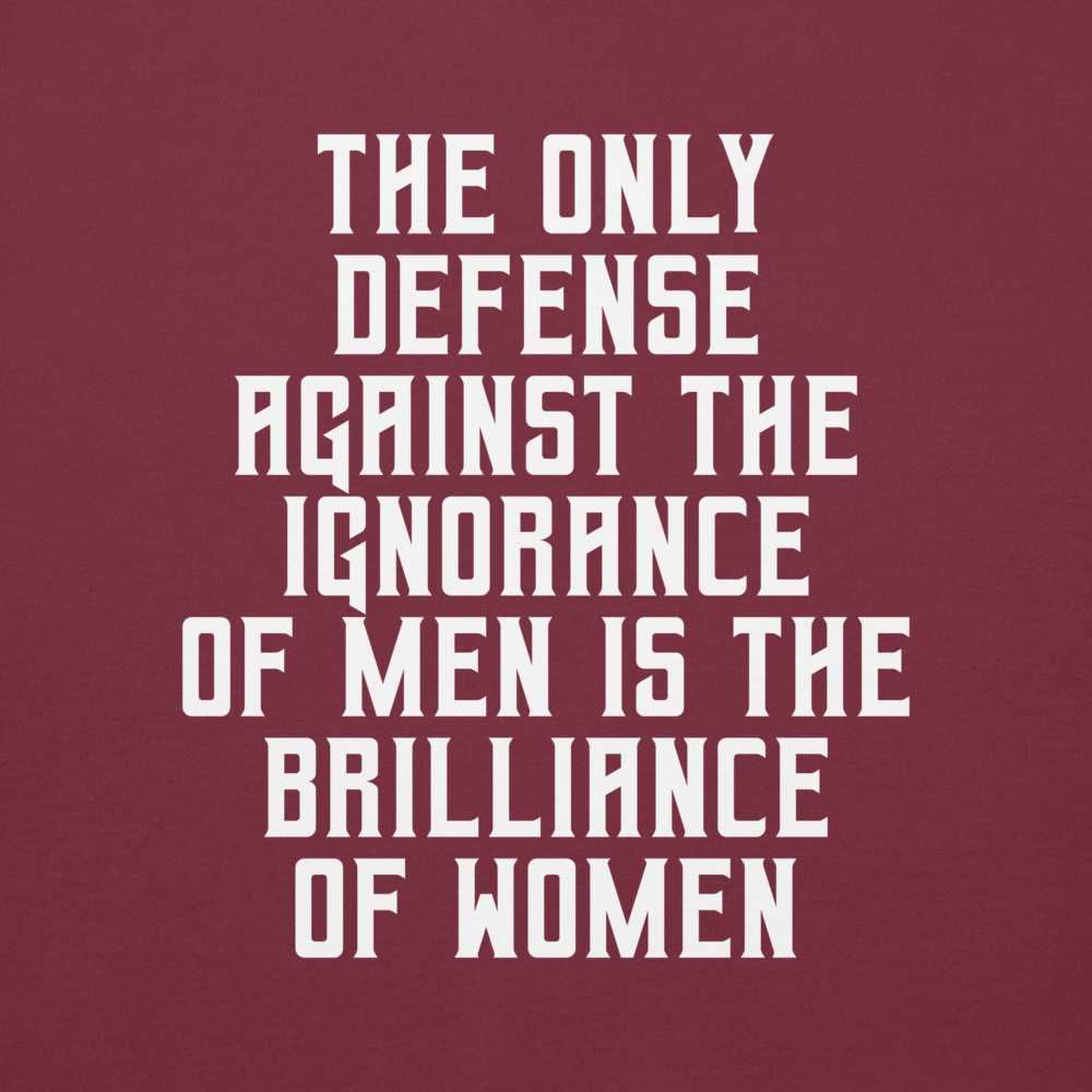 "The Only defense against the ignorance of men is the brilliance of women" printed on a maroon background