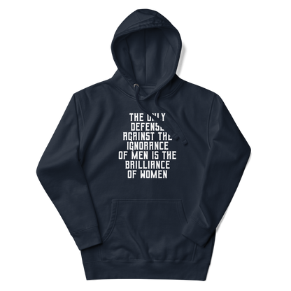 "The Only defense against the ignorance of men is the brilliance of women" printed on a navy blazer unisex hoodie laying on a flat surface with the hood up