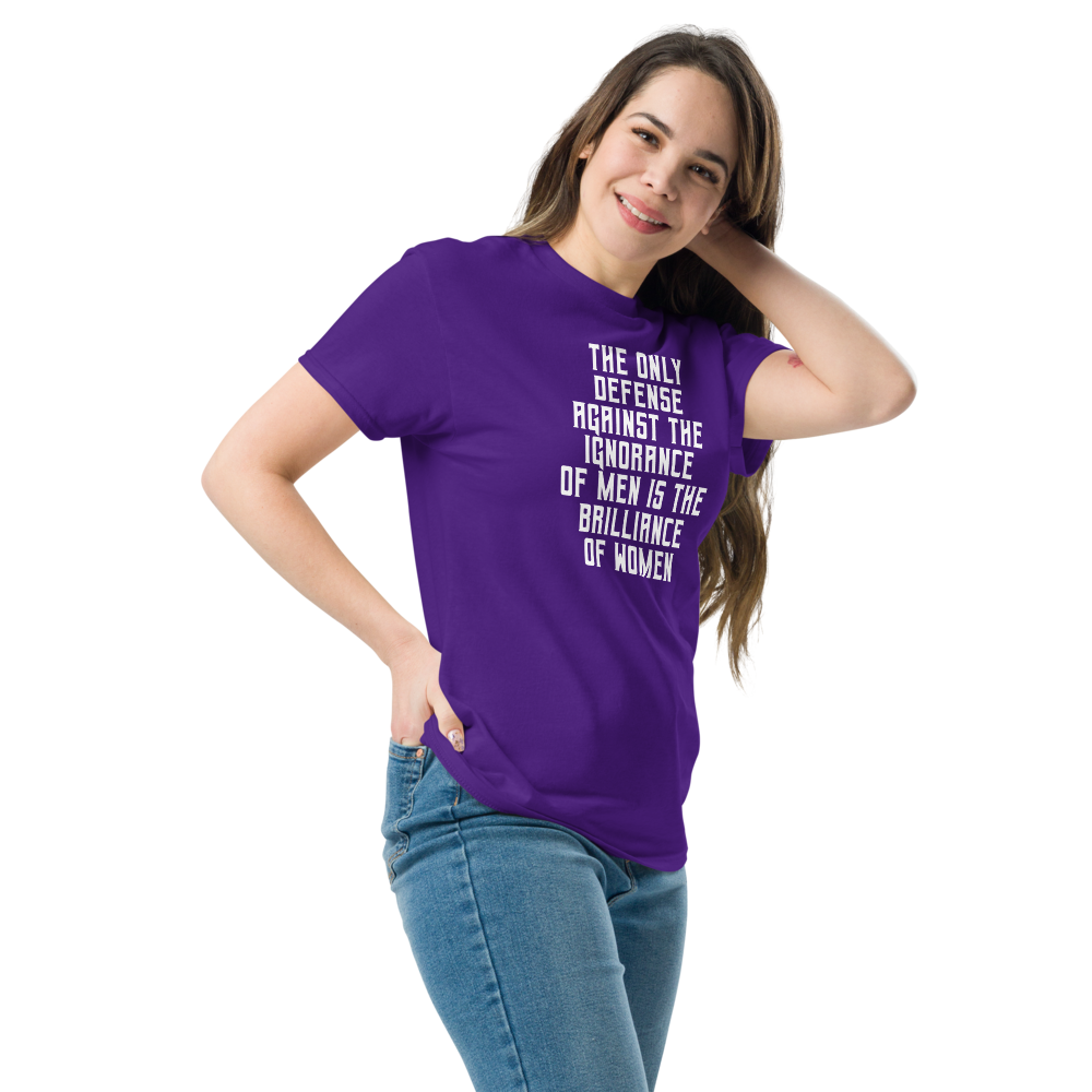 "The Only defense against the ignorance of men is the brilliance of women" printed on a purple unisex classic tee worn by a female