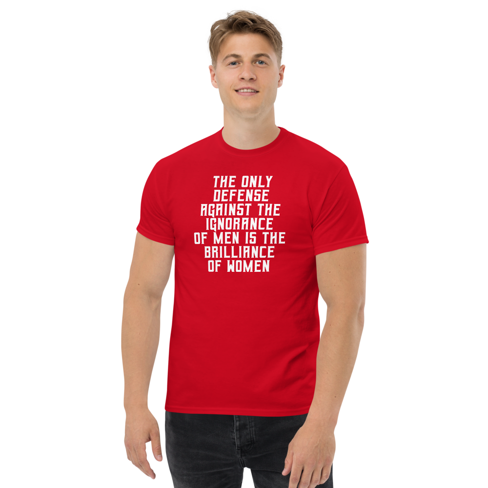 "The Only defense against the ignorance of men is the brilliance of women" printed on a red unisex classic tee worn by a male