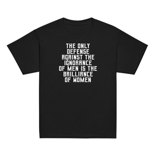 "The Only defense against the ignorance of men is the brilliance of women" printed on a black youth classic tee laying on a flat surface