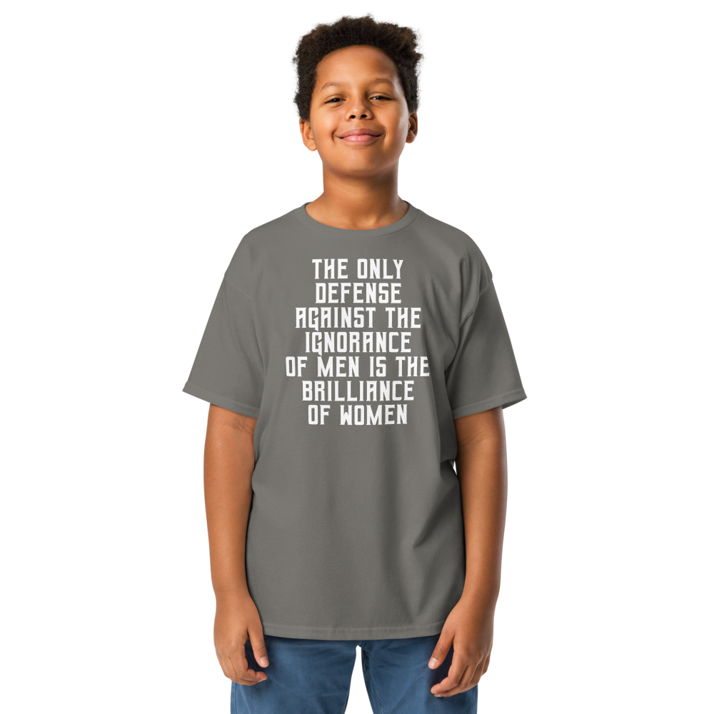 "The Only defense against the ignorance of men is the brilliance of women" printed on a charcoal youth classic tee worn by a male