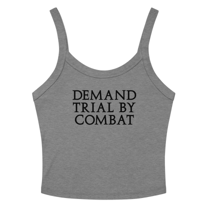 "Demand trial by combat" printed on a athletic heather women's micro-rib tanktop laying on a flat surface amongst sunglasses and shorts