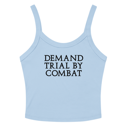 "Demand trial by combat" printed on a solid baby blue blend women's micro-rib tanktop laying on a flat surface amongst sunglasses and shorts