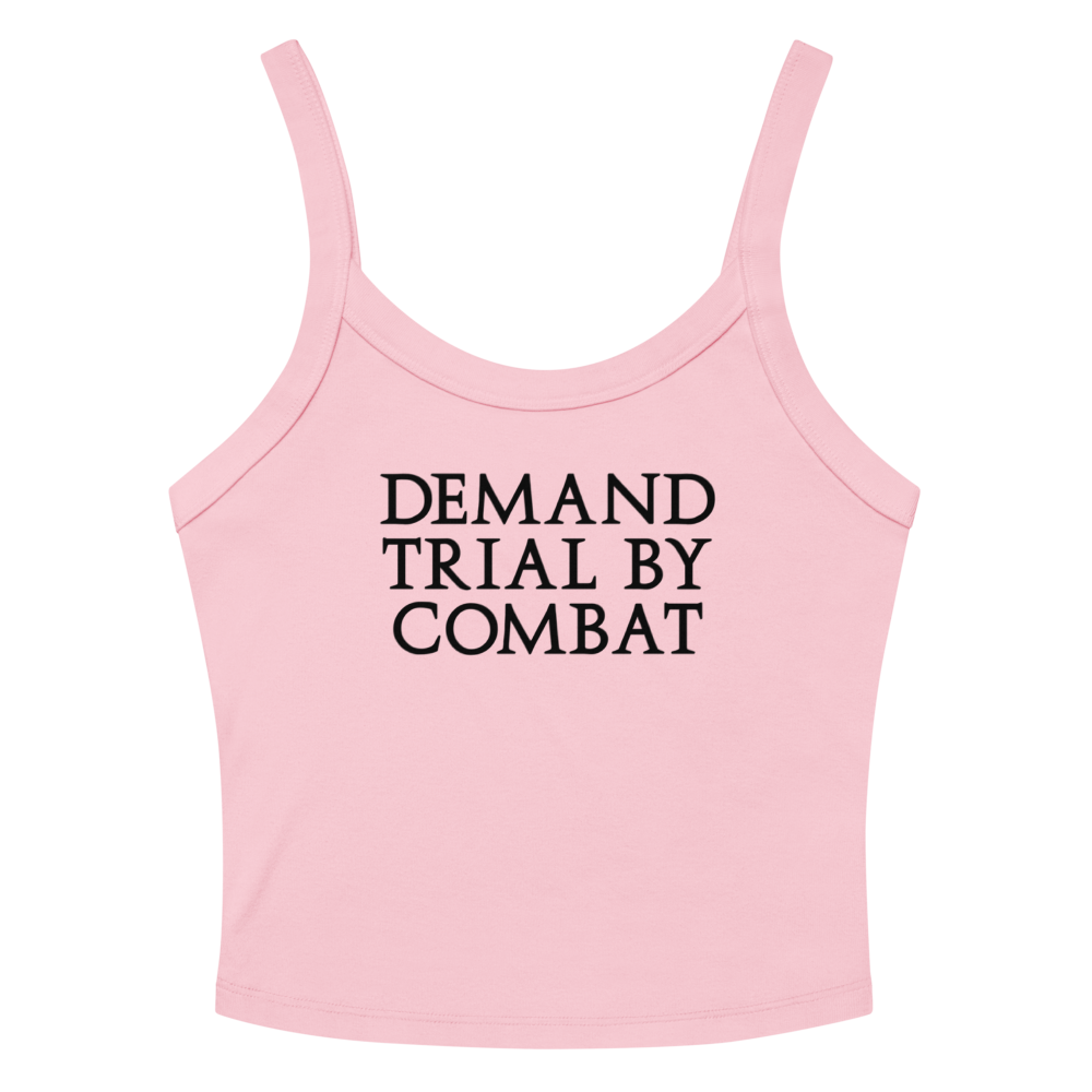 "Demand trial by combat" printed on a solid pink blend women's micro-rib tanktop laying on a flat surface amongst sunglasses and shorts