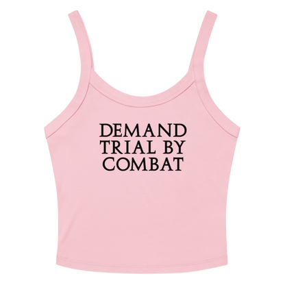 "Demand trial by combat" printed on a solid pink blend women's micro-rib tanktop laying on a flat surface amongst sunglasses and shorts