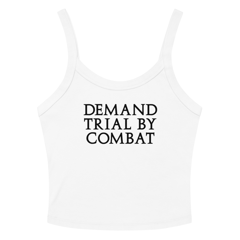 "Demand trial by combat" printed on a solid white blend women's micro-rib tanktop laying on a flat surface amongst sunglasses and shorts