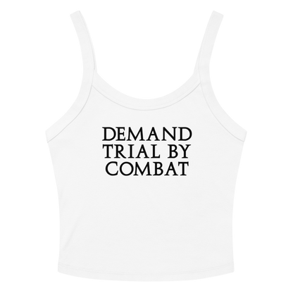 "Demand trial by combat" printed on a solid white blend women's micro-rib tanktop laying on a flat surface amongst sunglasses and shorts