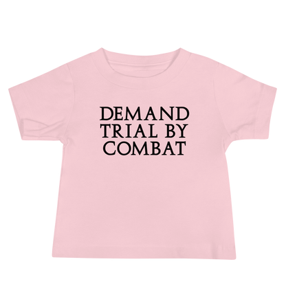 "Demand trial by combat" printed on a pink baby jersey short sleeve tee laying on a flat surface