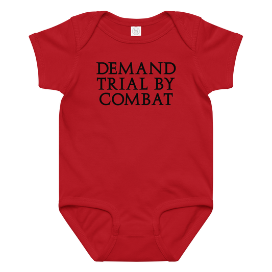 "Demand trial by combat" printed on a red baby jersey bodysuit laying on a flat surface amongst other clothes