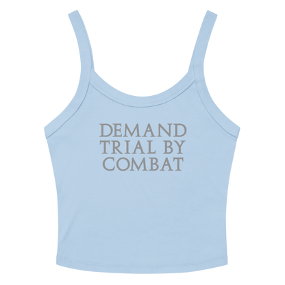 "Demand trial by combat" printed on a solid baby blue blend women's micro-rib tanktop laying on a flat surface amongst sunglasses and shorts