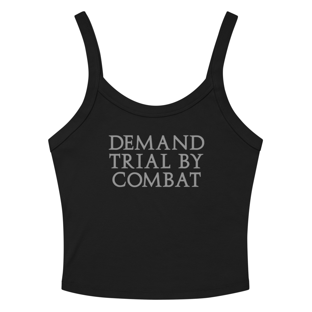 "Demand trial by combat" printed on a solid black blend women's micro-rib tanktop laying on a flat surface amongst sunglasses and shorts