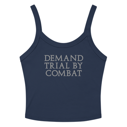 "Demand trial by combat" printed on a solid navy blend women's micro-rib tanktop laying on a flat surface amongst sunglasses and shorts