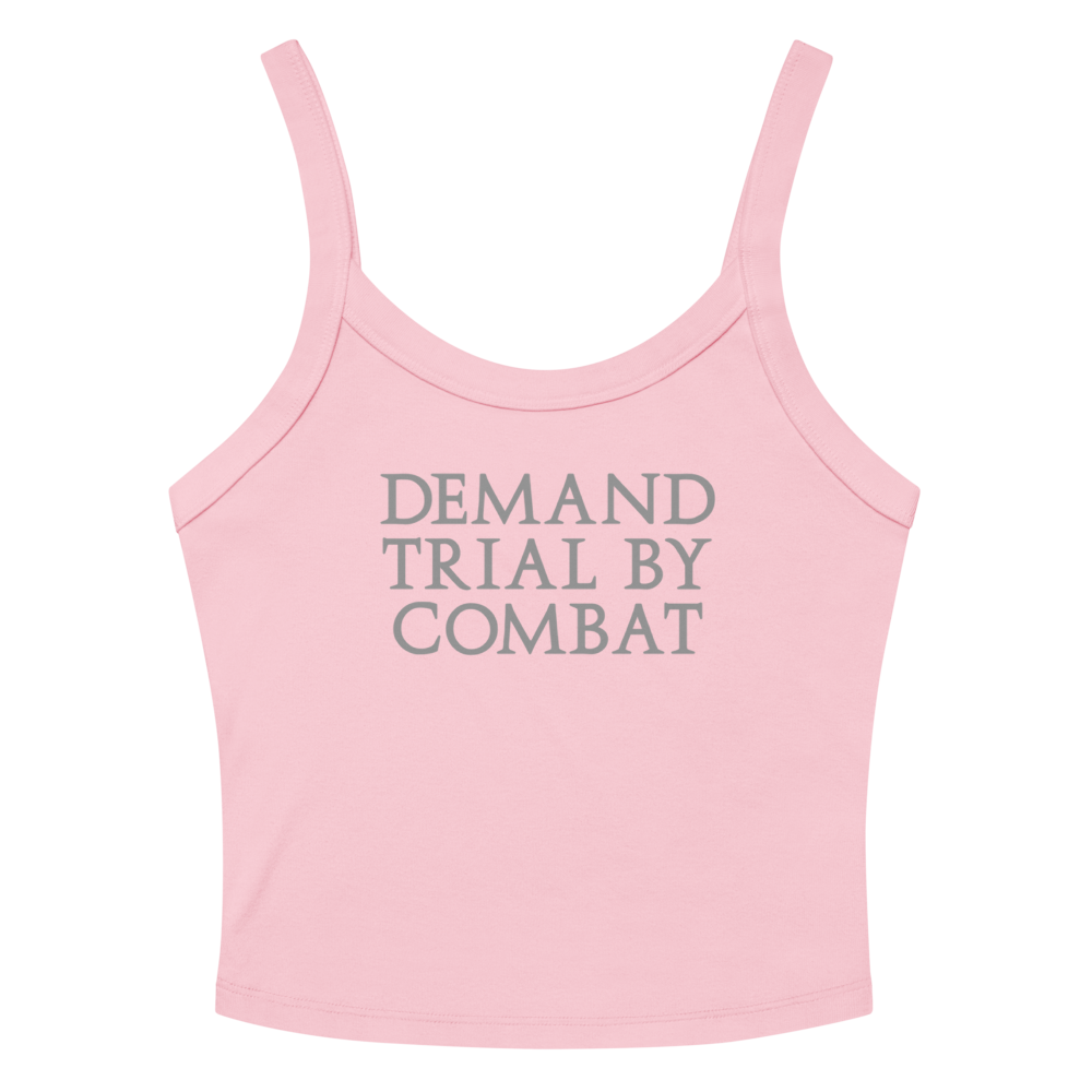 "Demand trial by combat" printed on a solid pink blend women's micro-rib tanktop laying on a flat surface amongst sunglasses and shorts